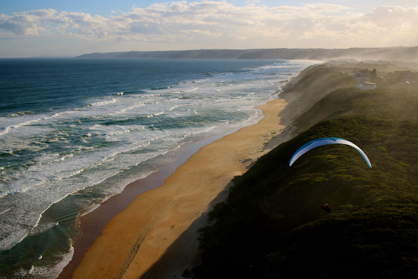Sunset soaring along the coastline of Wilderness in a Paraglider