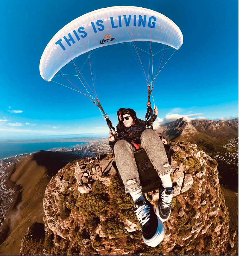 Paragliding over the top of Lions head with Seapoint and Table mountain in the background