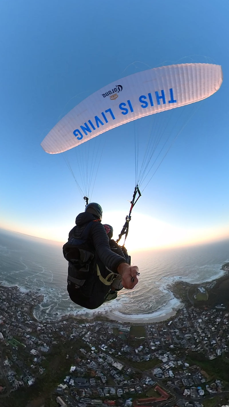 This is living Paraglider and Corona flying into the sunset over Camps Bay