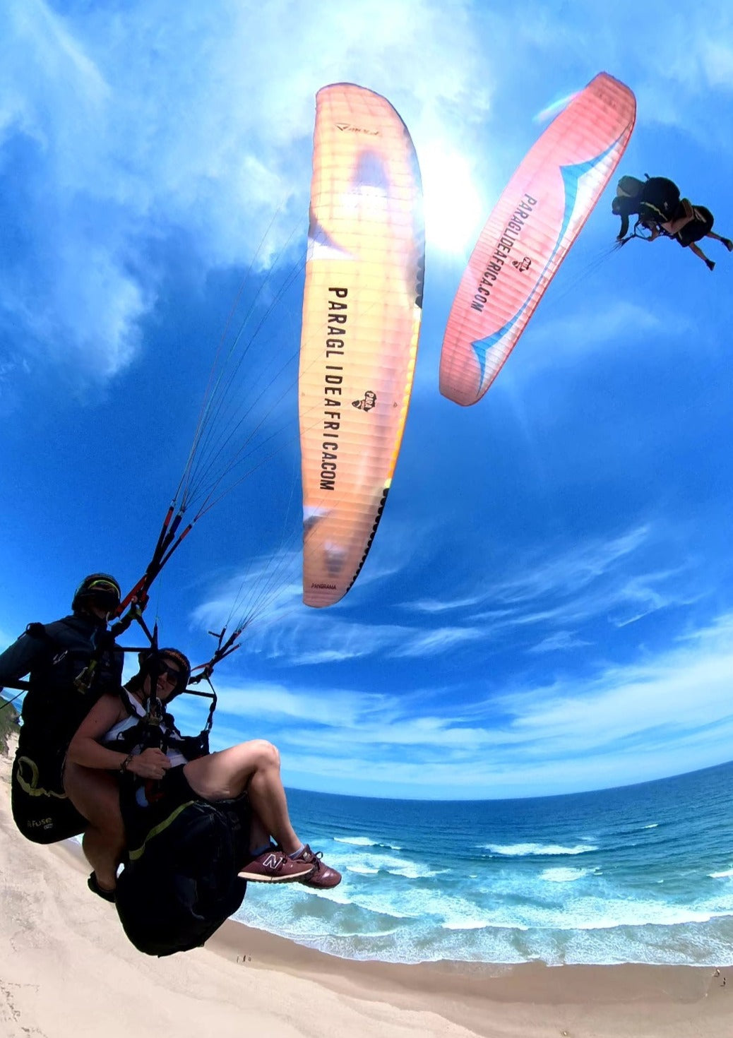 Two Paraglide Africa Tandem Experiences flying over the beach in Wilderness South Africa